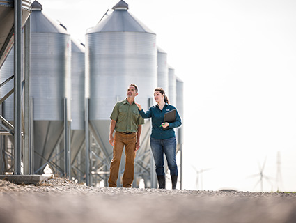 man and woman by feed bin