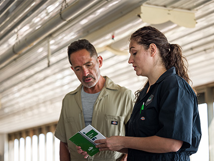 man and woman in pig barn